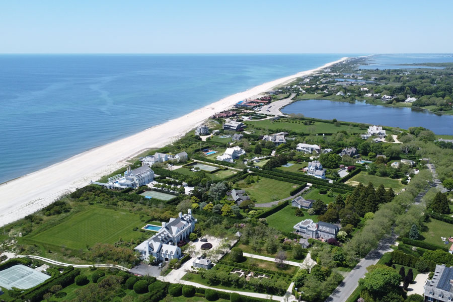A stunning aerial view of Southampton, New York, showcasing the pristine shoreline of the Atlantic Ocean and the sprawling estates that line the South Fork. This iconic stretch of the Hamptons reflects the town's blend of coastal elegance, historic charm, and luxurious living—making it one of the most desirable destinations on Long Island.