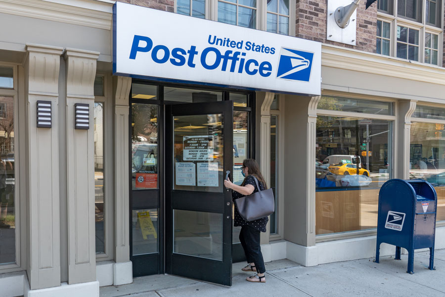 A customer enters a USPS location in Long Island City. Recent facility upgrades in both Suffolk and Nassau counties have made Long Island one of the fastest and most efficient mail delivery regions in the country.