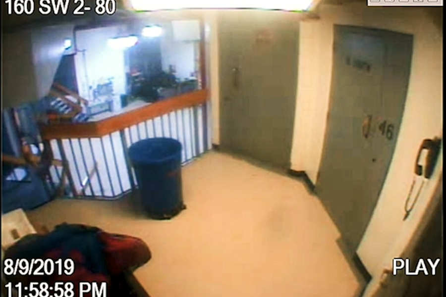A surveillance video frame from the Metropolitan Correctional Center dated August 9, 2019, timestamped 11:58:58 PM—just one second before the footage abruptly jumps to 12:00:00 AM, omitting the 11:59 PM minute entirely. This image became central to renewed scrutiny after reports revealed the government holds a complete version of the footage, suggesting the public release may have been edited or altered.
