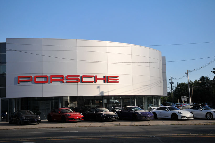 A Porsche dealership along Sunrise Highway in Freeport, Long Island (August 13, 2023). High-end car dealerships, shopping centers, and commercial hubs line portions of NY-27, reflecting its role as a major commercial corridor as well as a commuter route.