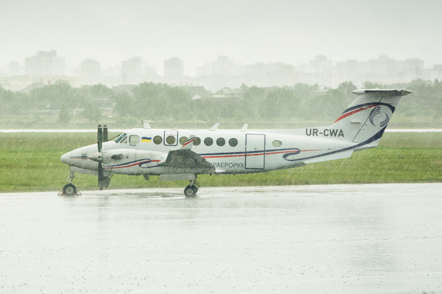 A Beechcraft King Air sits on a rain-soaked runway. Records show the New York Power Authority purchased a similar Beechcraft King Air B300 (King Air 350 series) in 2022, registered as N350NY, which has since been in active use for executive and trustee travel.
