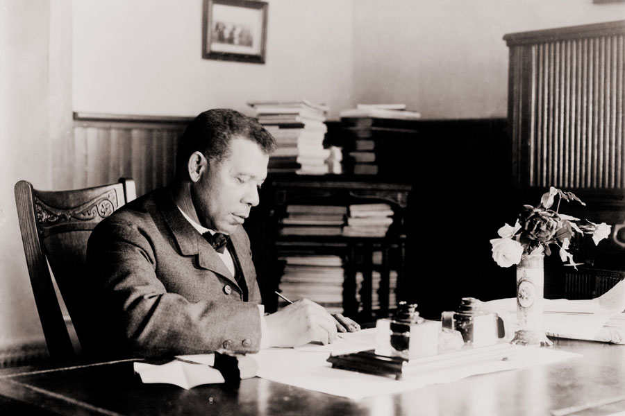 Booker T. Washington (1856–1915), pictured here writing at his desk, was a renowned educator, author, and leader. His inspirational autobiography, Up from Slavery (1901), became a bestseller and is celebrated for its powerful narrative of perseverance and achievement. Through his writing and leadership, Washington helped shape the path for African American progress and empowerment in the decades following emancipation. 