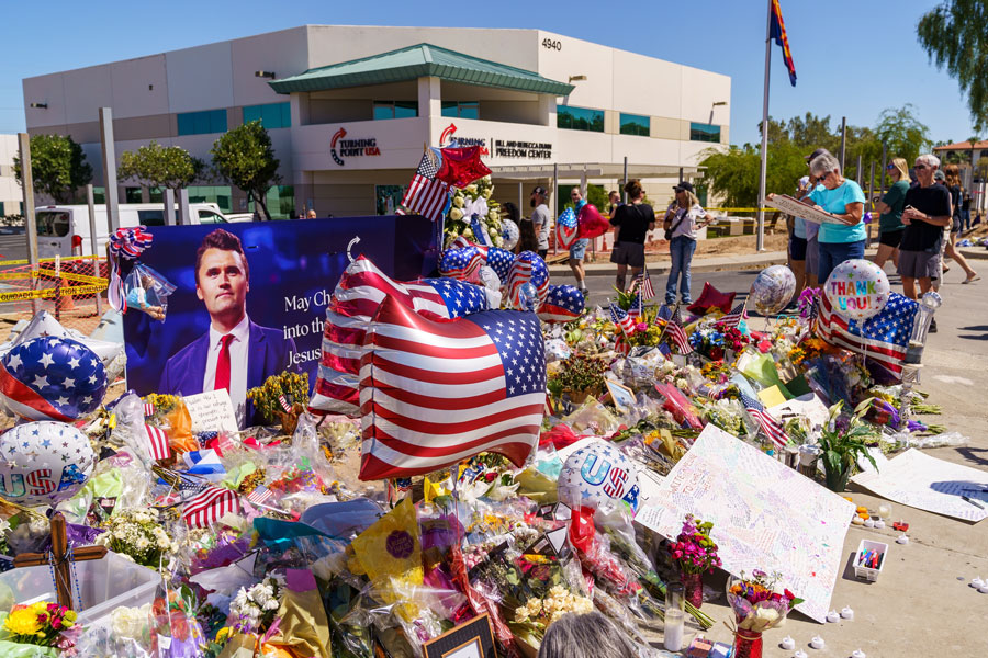 Phoenix, Arizona - September 13, 2025: People pay tribute at memorial at Turning Point USA Headquarters, after Charlie Kirk was killed fatally shot while speaking at Utah Valley University