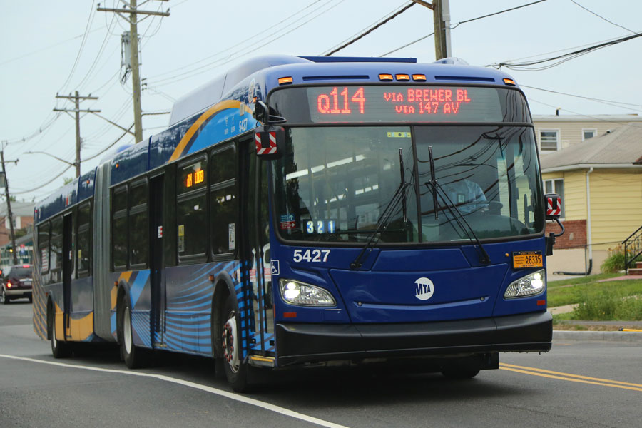 NEW YORK - JULY 28, 2016: New MTA bus in Queens borough in New York. MTA introduces new buses complete with Wi-Fi, USB charging ports and an upgraded design on May 2016.