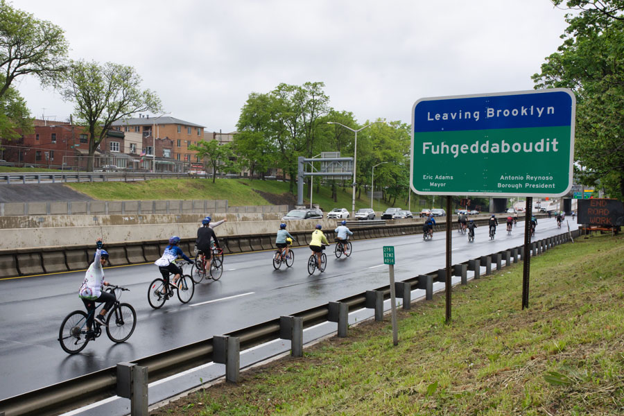 Cyclists make their way out of Brooklyn during the TD Five Boro Bike Tour, passing the borough’s famous Fuhgeddaboudit sign. The 47th annual event brought together 32,000 riders for a 40-mile journey through all five New York City boroughs on car-free streets.