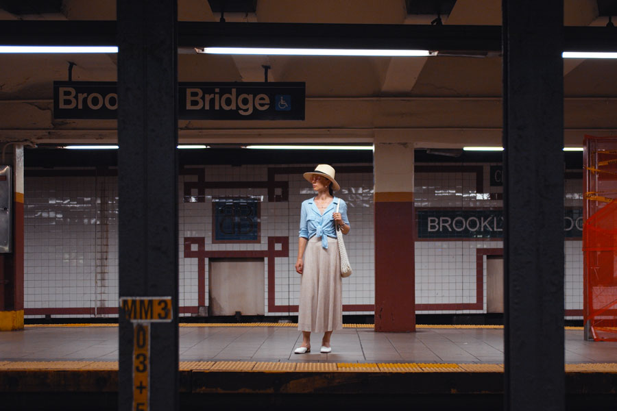 Young tourist waiting for a train at the station in the subway, New York City