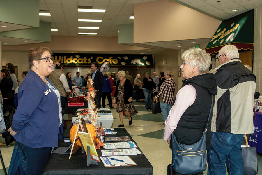 Attendees at a Long Island senior health expo visit information booths offering wellness and lifestyle resources.