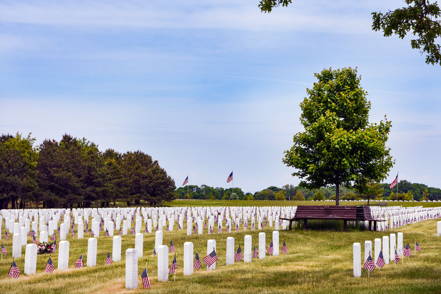 Flags placed at the headstones in Calverton National Cemetery in Calverton, New York, honoring fallen service members on Memorial Day.