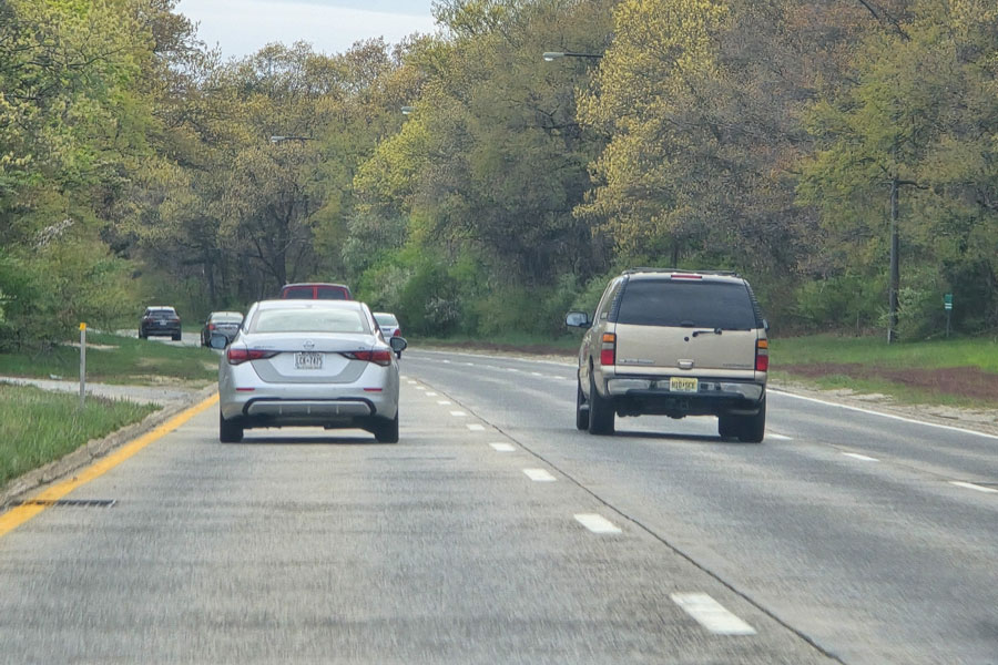 Vehicles traveling north on William Floyd Parkway surrounded by wooded scenery in Suffolk County, Long Island.
