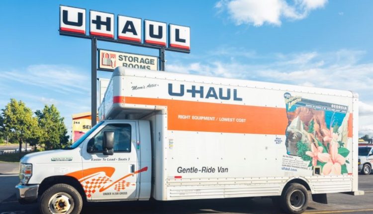 U-Haul moving truck parked in front of a U-Haul rental and storage facility, symbolizing relocation and moving services.