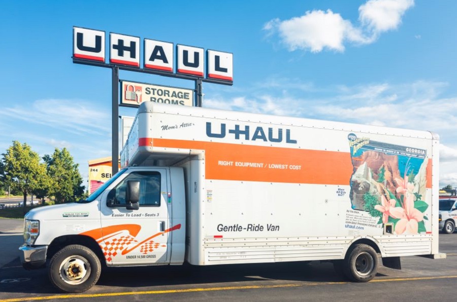 U-Haul moving truck parked in front of a U-Haul rental and storage facility, symbolizing relocation and moving services.
