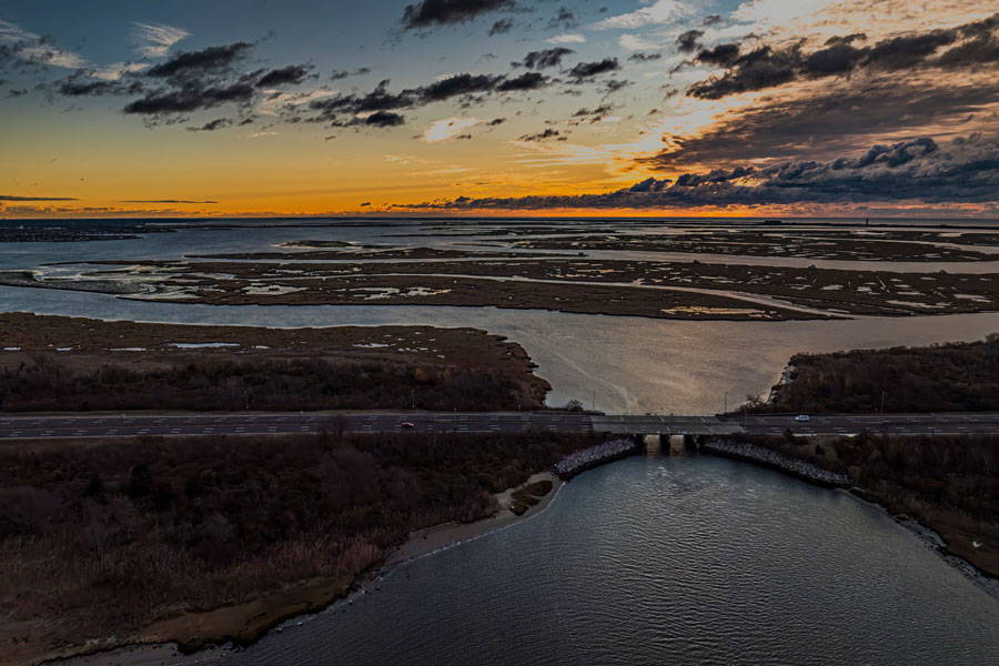 Aerial sunrise view of a parkway crossing marshlands over Baldwin Bay near Freeport, NY.