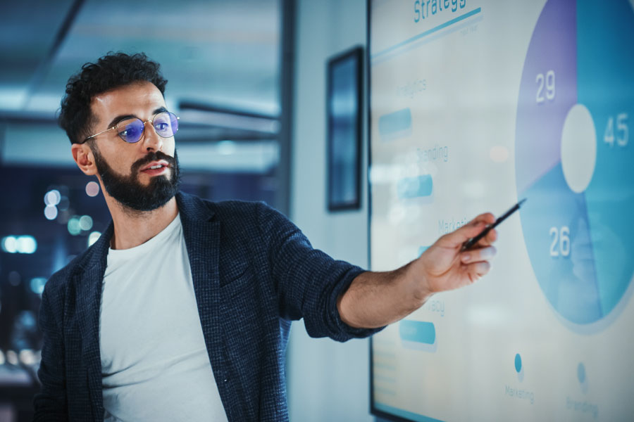 A marketing analyst reviews performance data during an internal strategy session