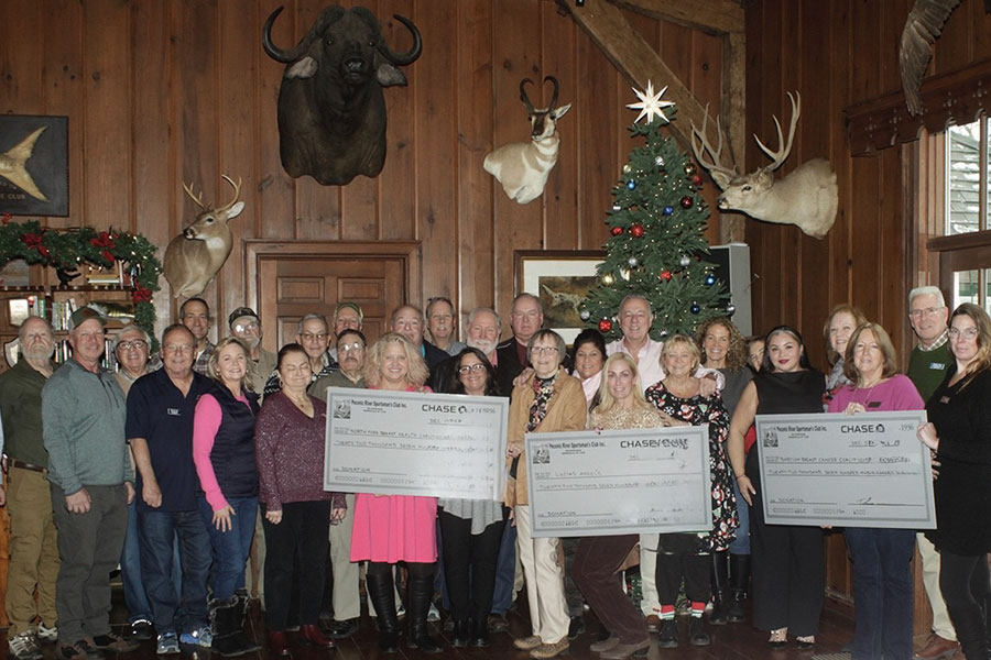 Group photo of Peconic River Sportsman’s Club members and representatives from the Babylon Breast Cancer Coalition, Lucia’s Angels, and the North Fork Breast Health Coalition holding donation checks at a luncheon in Manorville, New York.