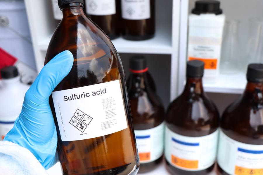 Bottle of sulfuric acid in a laboratory setting, used as a representative image in a Suffolk County chemical assault case.