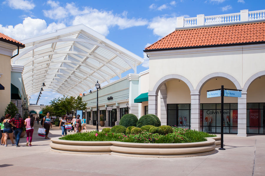Shoppers stroll through Tanger Outlets Deer Park, a major retail destination located in the heart of Deer Park, New York. 