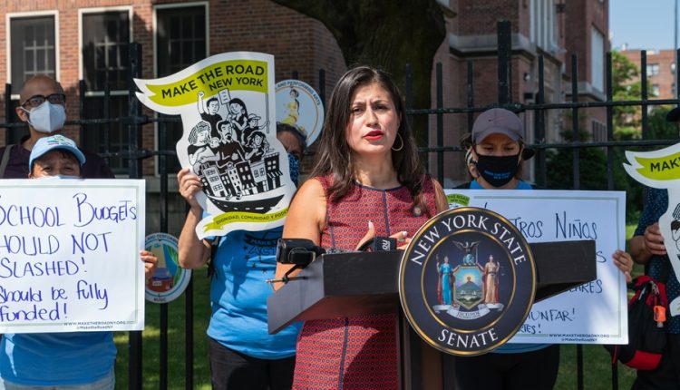 Public rally outside a New York public school highlighting concerns about school funding and annual education budget decisions