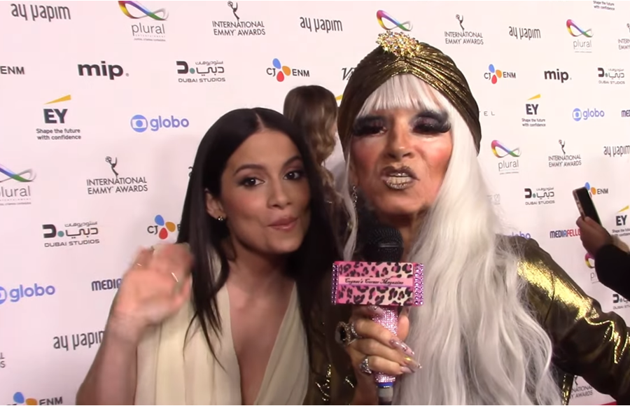 Actress Camila Pérez standing beside entertainment journalist Cognac Wellerlane during a red-carpet interview at the 2025 International Emmy Awards.