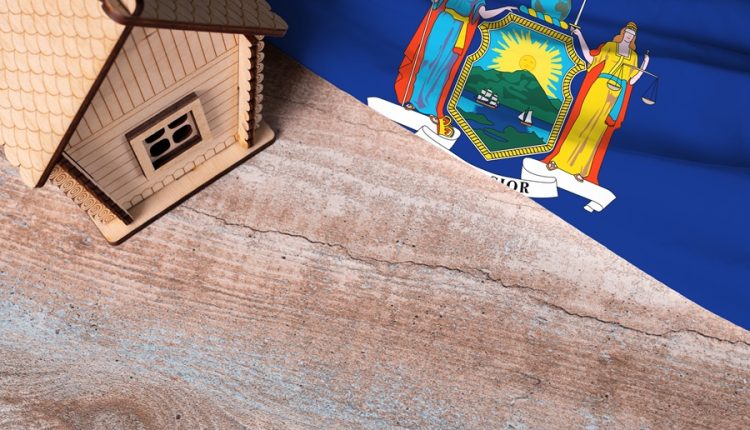 House model and New York State flag representing property tax assessments and grievance deadlines in Nassau and Suffolk counties