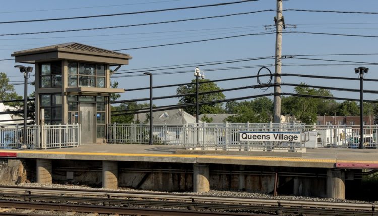 Train station sign showing a village name on Long Island, illustrating how place names do not always reflect municipal structure