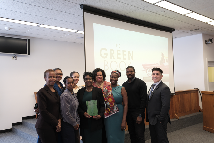 The Suffolk Courts Black History Month Planning Committee poses with a copy of The Green Book (L-R): Supervising Judge of Supreme Court Matrimonial Parts Hon. Cheryl Joseph, Court Attorney-Referee Darlene Jorif-Mangane, Family Court Judge Hon. Mary Porter, Principal Court Attorney Diane Clarke, Principal Law Clerk Patricia Waite, Family Court Judge Victoria Gumbs-Moore, Court Attorney-Referee Andrea Amoa, Principal LAN Administrator Ode Jean-Claude, and Justice Coordinator Joseph Benedetto.
 