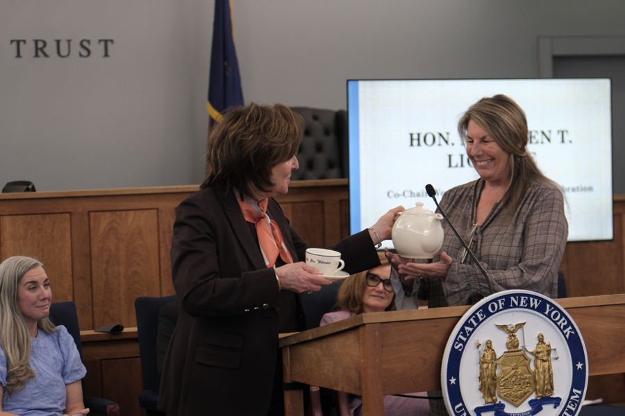 Associate Justice of the Appellate Term, Second Department, for the 9th and 10th Jud. Dists., Hon. Maureen Liccione presents a ceremonial tea set to keynote speaker, Lisa Gatti.
