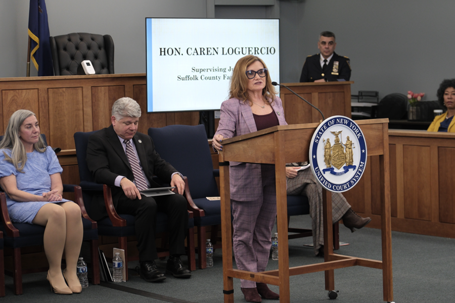 Supervising Judge of Suffolk’s Family Court Hon. Caren Loguerio gives heartfelt remarks as she presents the Hon. Mary Werner Award to family members of her late friend, Hon. Theresa Whelan.