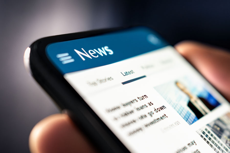 A close-up view of a smartphone displaying a generic news app highlights how more people are turning to digital platforms to stay informed, reflecting the growing role of online news consumption.