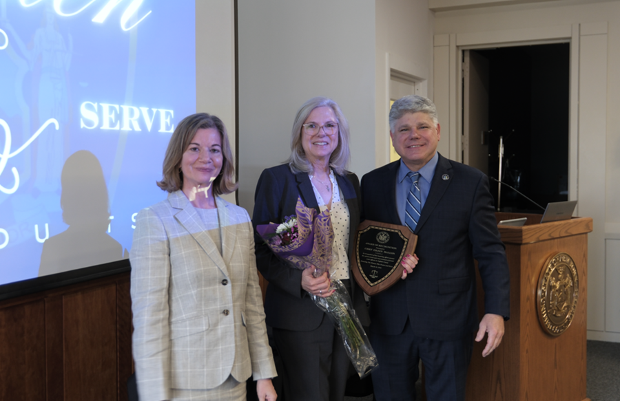 (L-R) Suffolk Women’s Bar Association President Renee Pardo, Esq., Chief (Ret.) Eileen Mallon, and District Administrative Judge Hon. Andrew Crecca stand together after bestowing Chief Mallon with a special recognition award.  