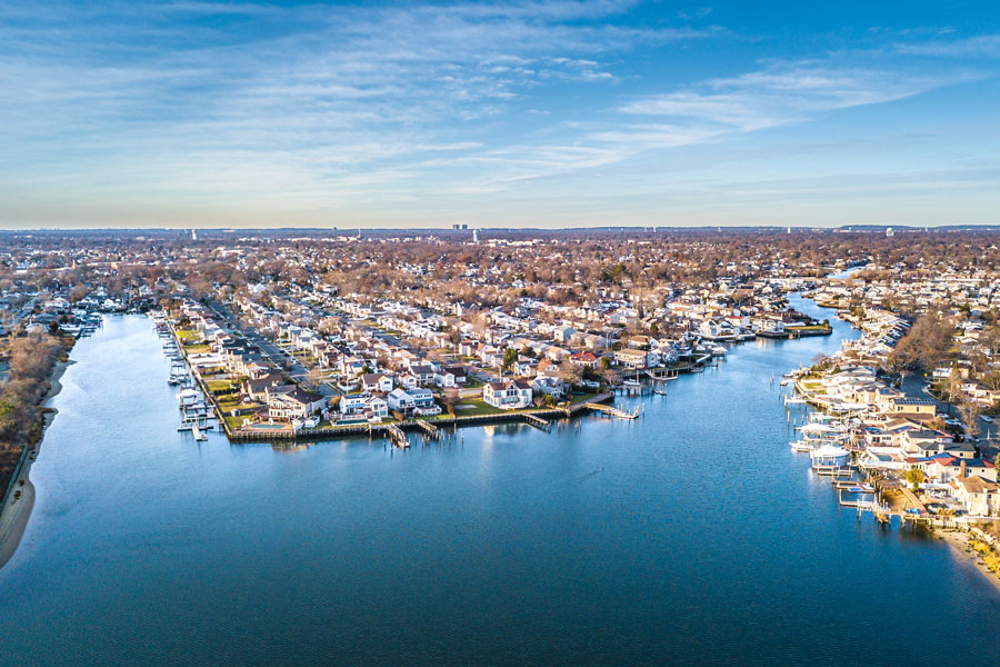 Baldwin Harbor’s waterfront neighborhoods stretch along a network of canals and inlets on Long Island’s South Shore, where many homes feature private docks and direct access to the bay. The area is known for its boating lifestyle, quiet residential streets, and scenic coastal views. Aerial view looking across Baldwin Harbor, Nassau County, New York.