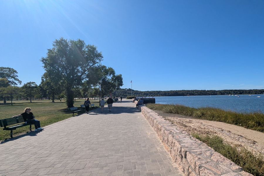 A view of the waterfront promenade at Theodore Roosevelt Memorial Park in Oyster Bay, New York, where visitors enjoy walking paths, harbor views, and open green space along the North Shore. Located near Sagamore Hill, the park serves as both a community gathering place and a tribute to President Theodore Roosevelt’s lasting connection to the area.