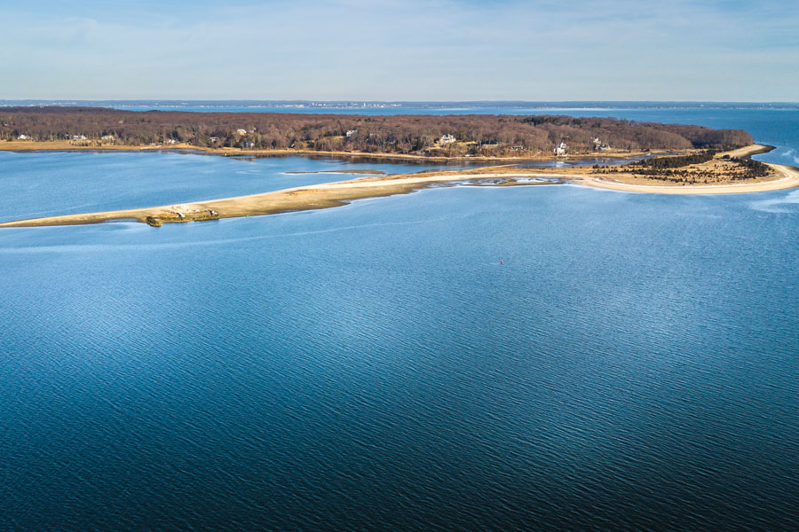 Gardiners Bay, Long Island, New York – Aerial view from the North Shore showing the calm blue waters, sandy shoreline, and coastal landscape near Shelter Island, where the bay connects the North and South Forks. 