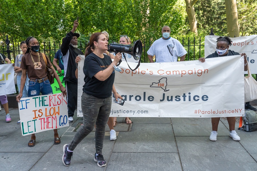 Protesters gather outside City Hall in Lower Manhattan advocating for parole reform and the early release of incarcerated individuals in New York State. Demonstrators hold signs and banners supporting Parole Justice as part of a broader push for criminal justice reform policies.