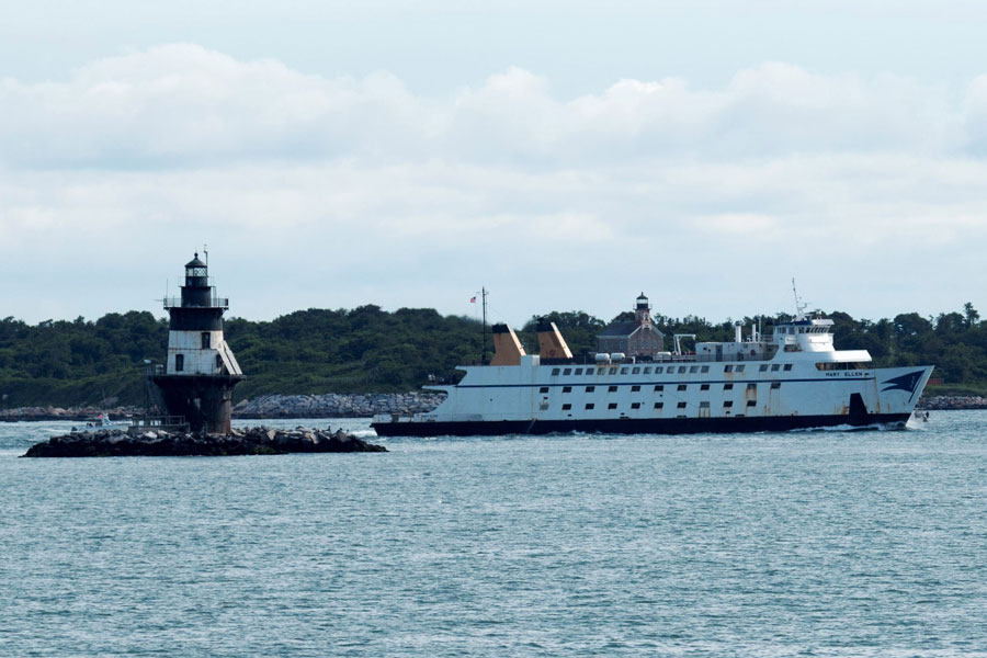 A Cross Sound Ferry vessel passes a lighthouse while traveling across Long Island Sound near Orient Point on Long Island’s North Fork. The ferry route connects eastern Long Island with New London, Connecticut and serves as a major gateway to New England.