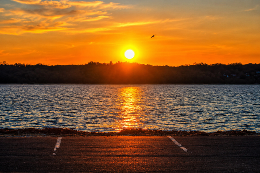Sunset over Sand City Beach in Eatons Neck on Long Island’s North Shore, where the evening sun reflects across the calm waters of the Long Island Sound along the scenic Suffolk County coastline.