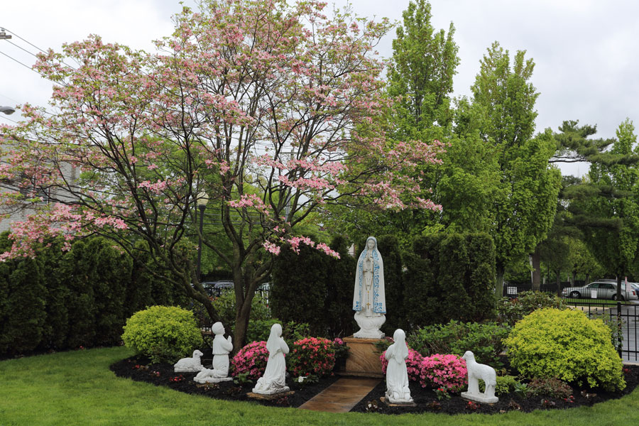 St. Hedwig’s Roman Catholic Parish garden in Floral Park, Long Island, featuring religious statues and landscaped grounds that reflect the village’s longstanding Polish-American Catholic heritage in Nassau County, New York.