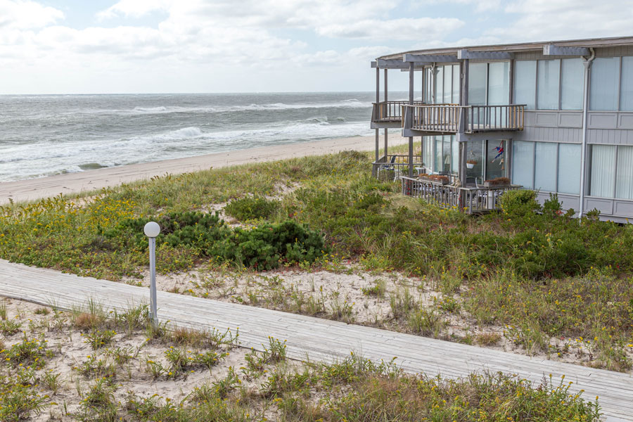 Oceanfront homes overlook the Atlantic shoreline in Westhampton Dunes, New York, where elevated boardwalks cross protected sand dunes along Long Island’s South Shore. The incorporated village is known for its quiet coastal setting, resilient dune system, and beachfront residential communities.