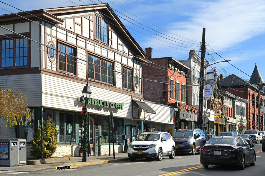 A streetscape view in Nesconset, New York, featuring local storefronts and everyday activity along a central commercial corridor, reflecting the hamlet’s blend of suburban living and neighborhood convenience in Suffolk County, Long Island.