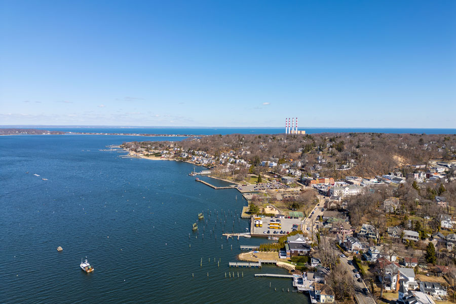 A drone aerial view of Northport Bay and Bird Island along Long Island’s North Shore, showcasing the scenic waterfront, village shoreline, and coastal beauty near East Northport, New York.