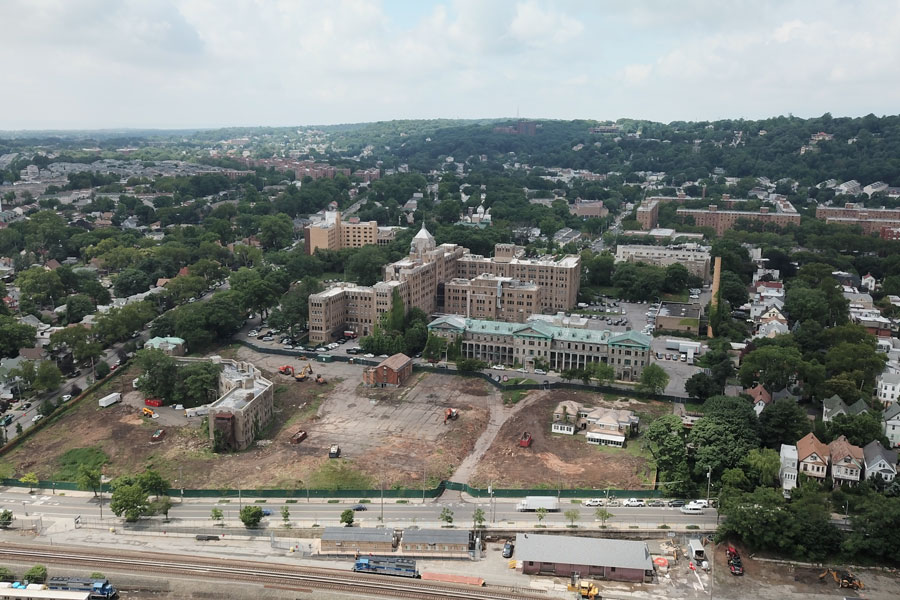 Aerial drone view of Sunrise Highway (NY-27) and surrounding residential neighborhoods near Route 112 in Patchogue, New York, showing ongoing development and the dense suburban layout of the South Shore community.