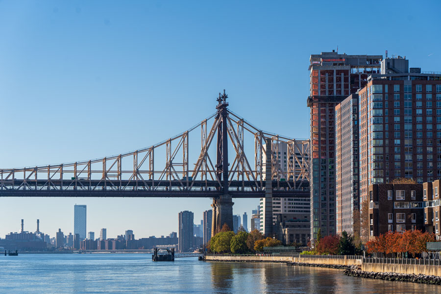 The Queensboro Bridge stretches across the East River between Manhattan and Queens as seen from Roosevelt Island in New York City. The historic bridge remains one of the major transportation crossings used by commuters and travelers connected to Long Island and the surrounding metropolitan region. File photo: licensed.