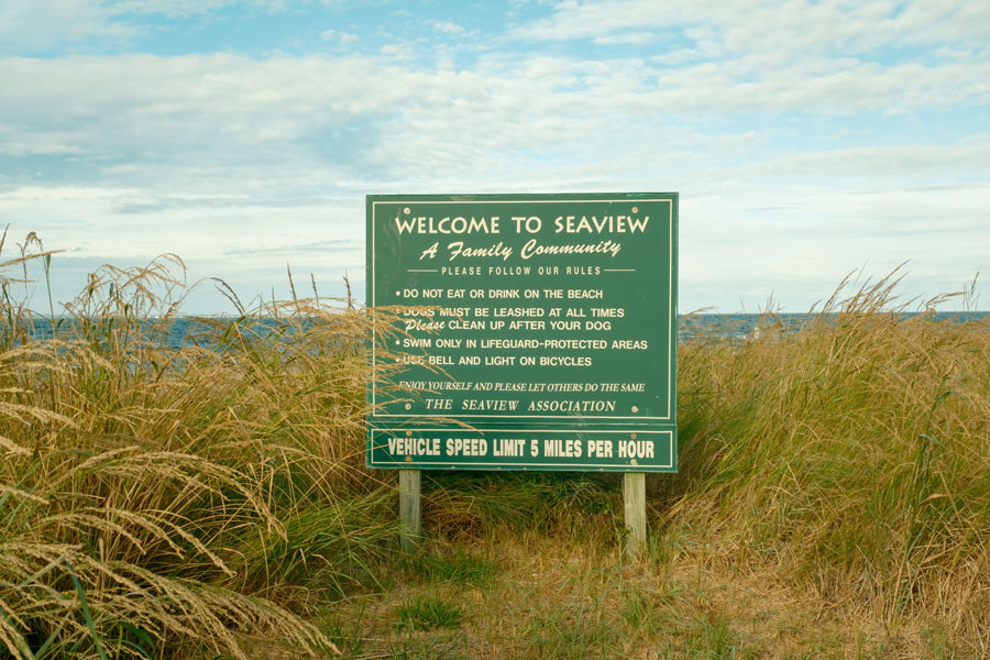 A welcome sign stands among the dunes in Seaview on Fire Island, a quiet residential beach community known for its relaxed atmosphere and family-oriented coastal setting.