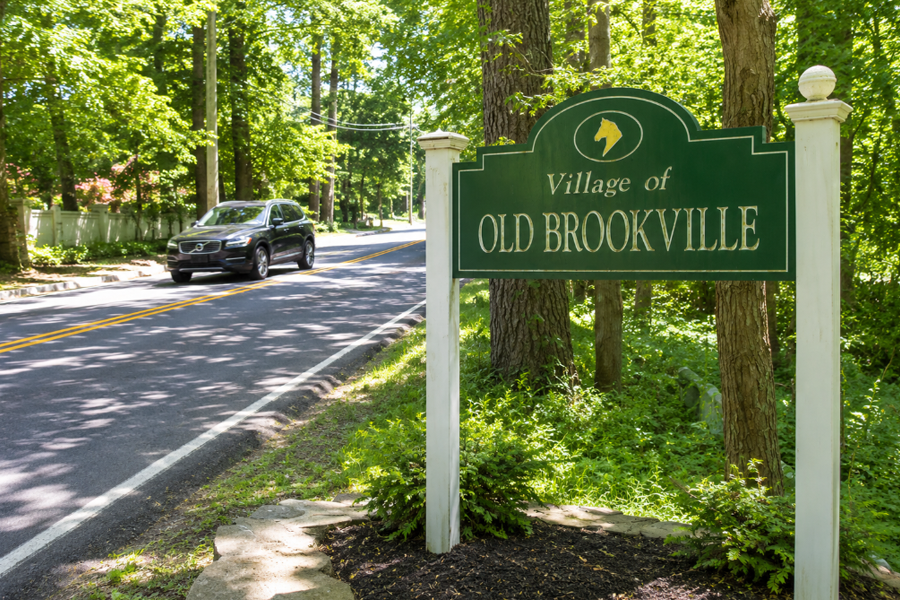 The entrance sign for the Village of Old Brookville welcomes visitors along a quiet, tree-lined roadway on Long Island’s North Shore. Known for its Gold Coast heritage, estate properties, and wooded landscapes, Old Brookville remains one of Nassau County’s most picturesque residential communities. The village's scenic roads and mature tree canopy reflect the character and natural beauty that have long defined this historic North Shore enclave.