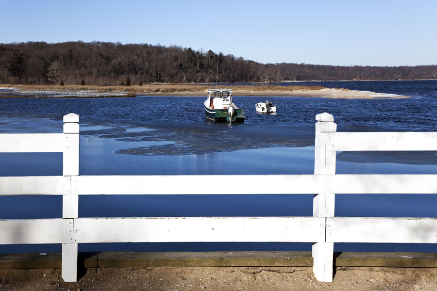 Small boats rest along a quiet shoreline in Laurel Hollow overlooking Oyster Bay Harbor. The village's protected coves, marshes, and waterfront landscapes help define its North Shore character and contribute to the scenic environment that has long attracted residents to this part of Long Island's Gold Coast.