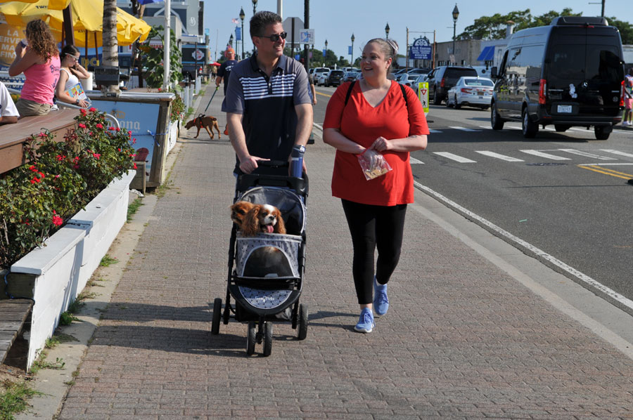 Visitors stroll along Woodcleft Avenue in the heart of Freeport's Nautical Mile, where waterfront restaurants, marinas, charter fishing boats, and local shops create one of Long Island's most popular seaside destinations.