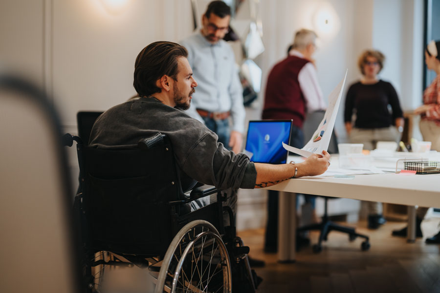 Inclusive workplace environment with diverse team engaging in business projects.