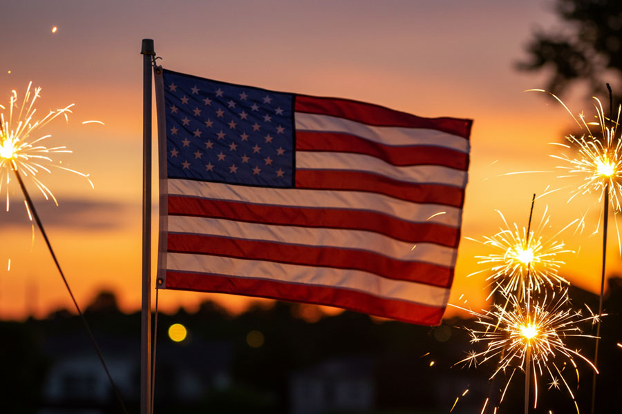 An American flag waves against the backdrop of a summer sunset as fireworks light the evening sky. For many Americans, the nation's 250th anniversary is a time to reflect on the country's history, freedoms, accomplishments, and the enduring sense of patriotism that continues to inspire generations.