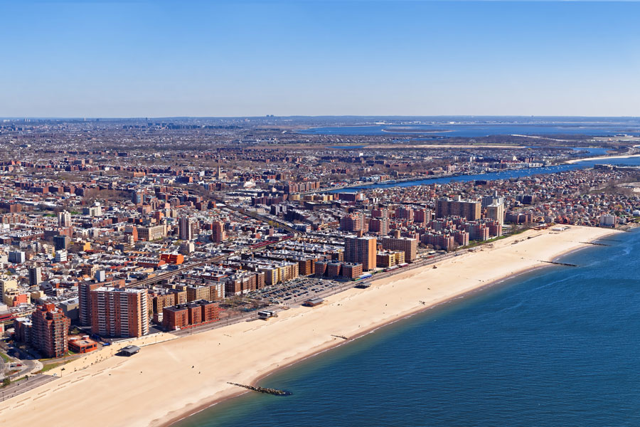 Aerial view of the western end of Long Island showing Brooklyn, Queens, Jamaica Bay, and the Atlantic coastline.