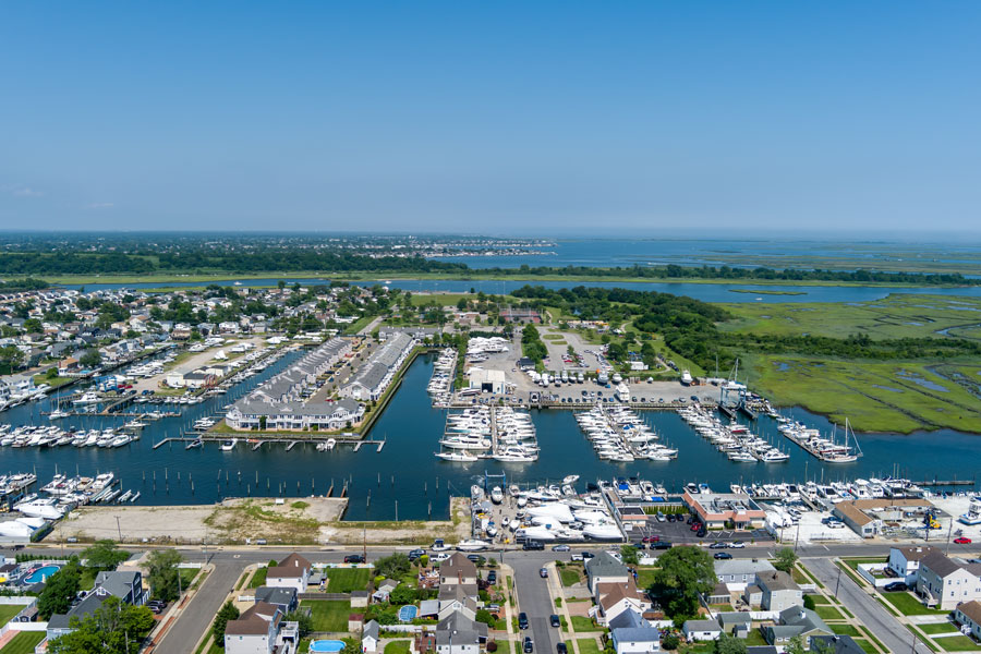 An aerial view of a marina in Babylon, Long Island, overlooking the Great South Bay. The protected harbor is filled with recreational boats, yachts, and waterfront facilities, illustrating why Babylon is one of Long Island's most popular boating communities and a gateway to Fire Island, fishing, and South Shore cruising. File photo: ECL Media LLC, licensed.