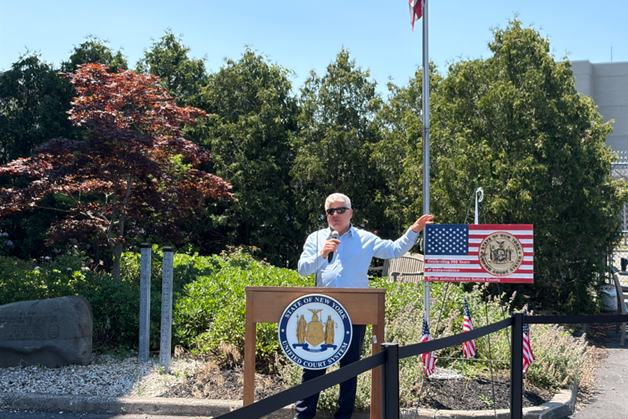 Suffolk County District Administrative Judge Hon. Andrew Crecca welcomes employees to the court’s celebratory barbecue at the Arthur M. Cromarty Courthouse in Riverhead.